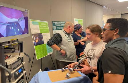 Kai Britton of Hartland, VT, participates in a laparoscopic procedure demonstration using a Lite Brite® toy at 最新澳门博彩平台注册卫生’s 2023 Career Expo.